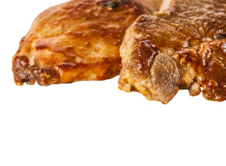 two pieces of baked meat on white background