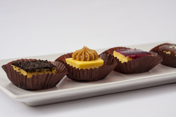 Mini cheesecakes mix on square white plate