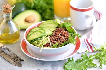 Healthy salad with quinoa, avocado, cucumber and spaghetti from zucchini with lettuce leaf 
 and olive oil.
