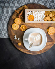 Cup of Cocoa with marshmallows, cookies in wooden box. Dark wooden background.