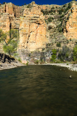 Fototapeta na wymiar River leading up to large cliffs