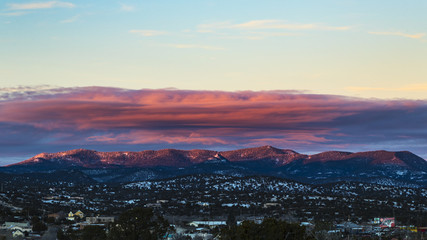 sunset over mountain range with slight dusting of snow