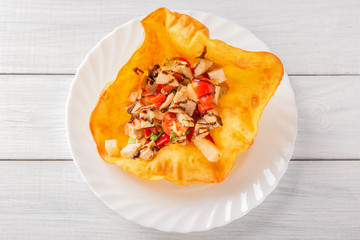 Fried chicken meat with tomatoes and sauce in pita bread on white wooden table. Top view