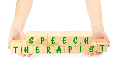 Speech therapy concept. Hands holding cubes on white background