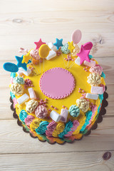 Colourful children's cake decorated with marshmallows and meringues