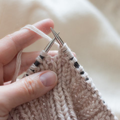 Lessons knitting by hand on needles and beige thread