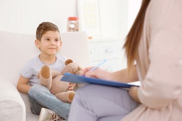 Young child psychologist working with little boy