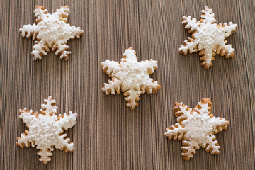 Gingerbread snowflake on wood background. Aerial view.