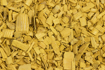 Yellow wood chips texture, wooden decorative background.