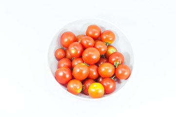 Ripe cherry tomatoes in a bowl on white background
