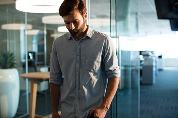 Unhappy businessman looking down
