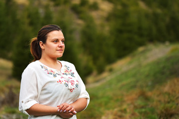 Outdoors portrait of beautiful young brunette woman