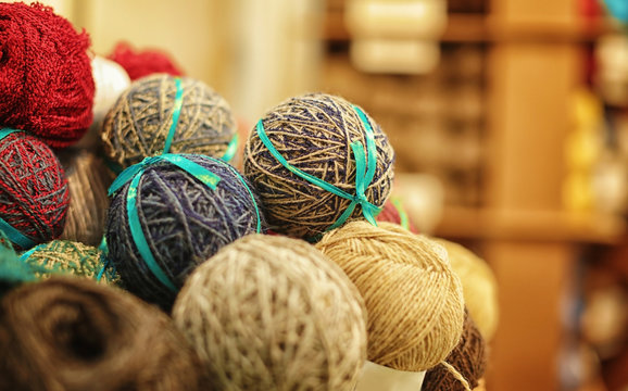 Balls of knitting yarn on blurred background