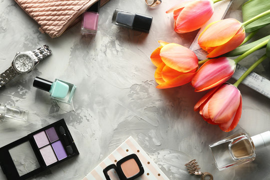 Beautiful composition of cosmetics with tulips on table