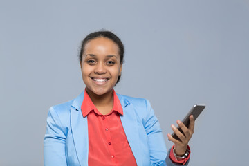 Fototapeta premium Young Business Woman Using Cell Smart Phone African American Girl Happy Smile Businesswoman Isolated Over Gray Background