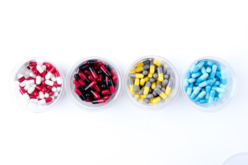 pile of medical pills and pills on white background.
