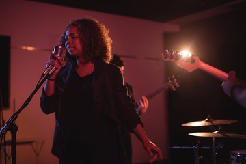Woman singing on retro microphone