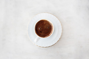 Coffee with a smiley face on it. 