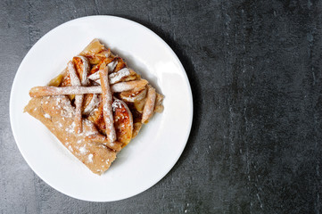 Apple galette, pie, tart with cinnamon on a grey stone background Top view