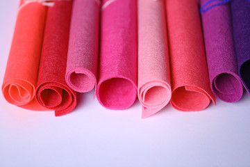 Felt in rolls of pink, purple, lilac colors on a light background. set for creativity and needlework