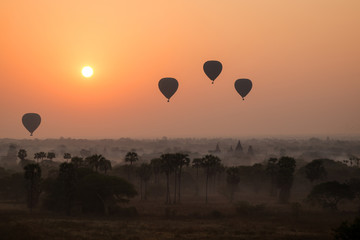 Silhouette of hot-air balloons over plain of Bagan at sunrise in Myanmar (Burma).