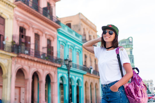 Tourist beautiful girl in popular area in old Havana, Cuba. Young woman traveler smiling happy.