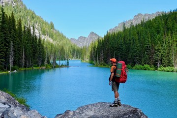 Man backpacker hiker by alpine lake. Nada Lake. The Enchantments. Cascade Mountains. North Cascades. Seattle. Leavenworth. WA. USA. 
