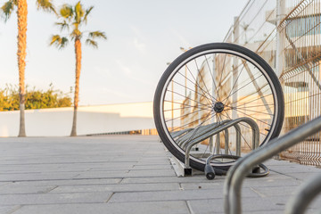 Stolen bicycle, Chained front bicycle wheel locked. A damaged bike wheel is all that is left, a...