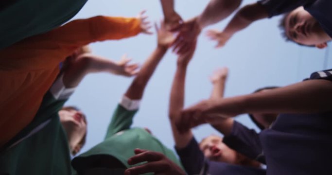 Children's soccer team bring it in for a cheer.