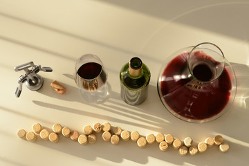 Red wine in decanter, glass and bottle on table