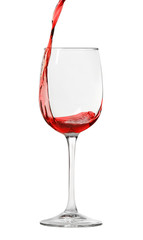 Pouring red wine into glass on white background