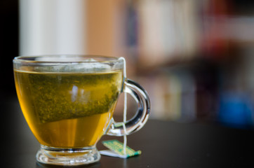 Green Tea in Glass Cup. Bokeh Background