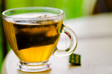 Green Tea in Glass Cup. Bokeh Background