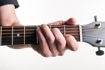 The guitarist's hand clamps the chord C on the guitar, on a white background. Horizontal frame