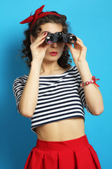 woman with binoculars. Pin up style.