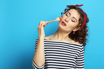 woman with a make-up brush. Pin up style.