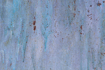Rusted painted metal wall corrosion with streaks of rust
