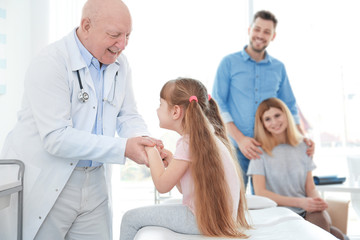 Little girl with parents at orthopedist's office