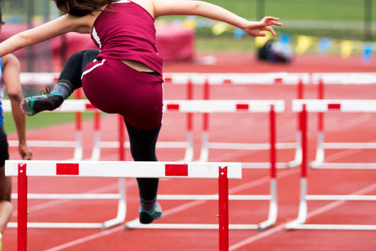 High School Girls Track Hurdle Race From Behind