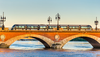 City tram on Pont de Pierre bridge in Bordeaux, France