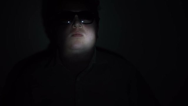 Portrait of a fat man in a multicolored light beam.