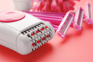 Modern epilator on color background, closeup