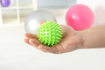 Male hand with stress ball in clinic