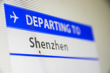 Computer screen close-up of status of flight departing to Shenzen, China