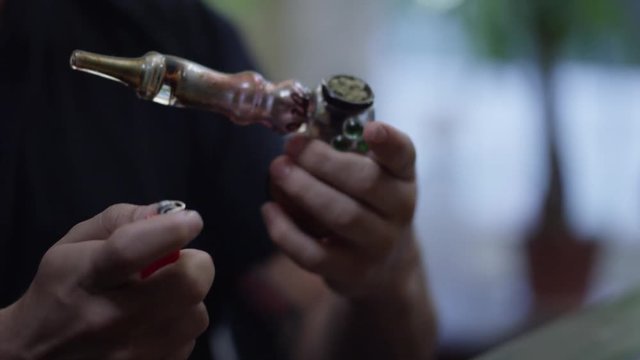 Man Smoking Weed from a Pipe/Bubbler