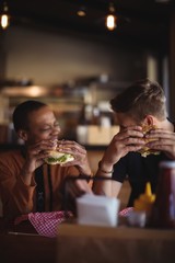 Happy couple having burger 