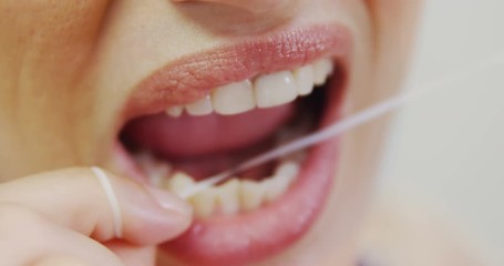 Female patient flossing her teeth