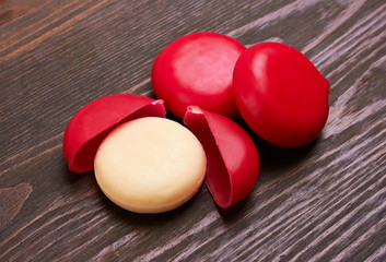 Round delicious cheese on wood