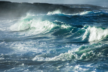 Naklejka premium Big stormy ocean wave. Blue water background