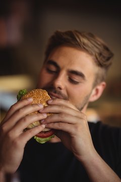 Close-up Of Man Eating Burger